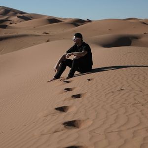 Smooth, flowing sand dunes in a desert landscape.